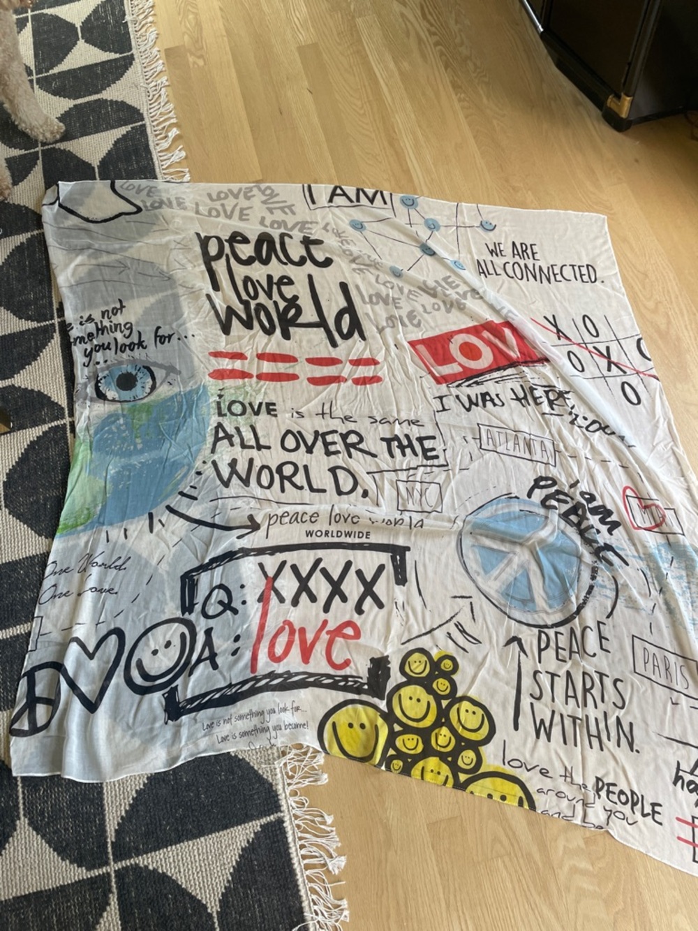 Peace Love World White Scarf with Red, Blue, Yellow & Black Graphics.